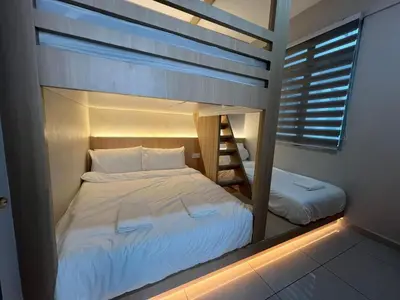 a bunk bed with a ladder in a room at PrimaStay Ipoh Palo for 7 Pax in Ipoh