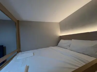 a bed with white sheets and pillows in a room at PrimaStay Ipoh Palo for 7 Pax in Ipoh