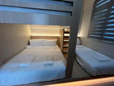 two bunk beds in a room with a window at PrimaStay Ipoh Palo for 7 Pax in Ipoh