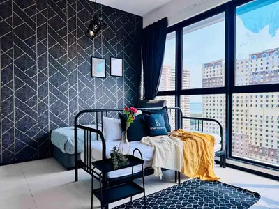 a bedroom with a bed and a large window at Urban suites 3BR 10pax in George Town