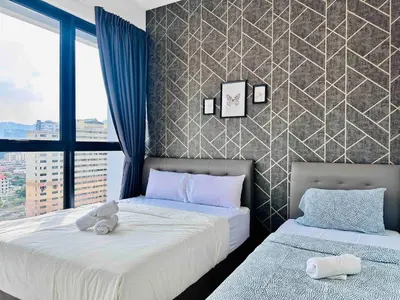 a bedroom with two beds with stuffed animals on them at Urban suites 3BR 10pax in George Town
