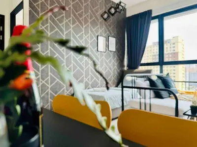 a bedroom with a bed and a plant in a room at Urban suites 3BR 10pax in George Town