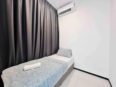 a small bedroom with a bed and a air conditioner at Urban suites 3BR 10pax in George Town