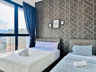 a bedroom with two beds with stuffed animals on them at Island Sea & City View Familystay 3BR 10Pax in George Town