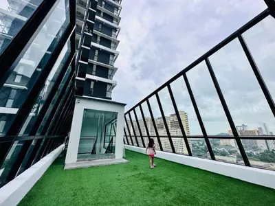 a little girl walking on the balcony of a building at Island Sea & City View Familystay 3BR 10Pax in George Town