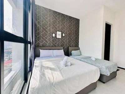 a bedroom with two beds and a window at Island Sea & City View Familystay 3BR 10Pax in George Town