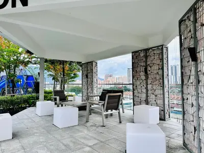 a patio with chairs and tables on a building at Peaceful Abode Familystay 3 br 10 pax in George Town