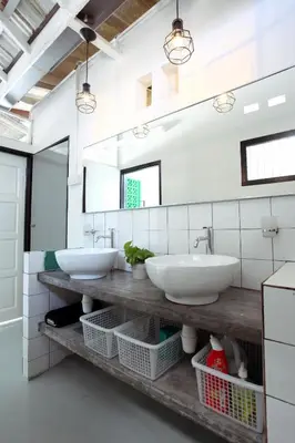 a bathroom with two sinks and a mirror at Stay SongSong Mount Erskine in George Town