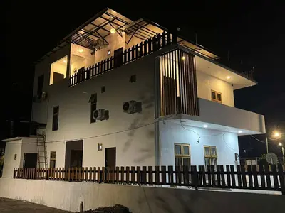 a large white building with a balcony at night at Hillview Bercham Height CoLiving Villa in Ipoh