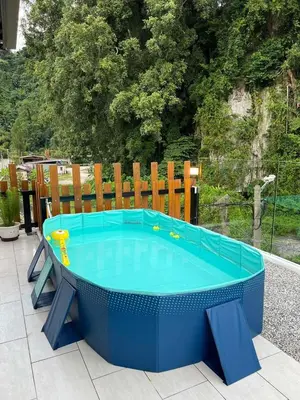 a large blue pool with a table on a patio at Hillview Bercham Height CoLiving Villa in Ipoh