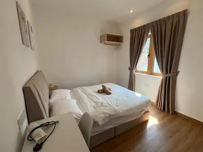 a bedroom with a bed with a teddy bear on it at Hillview Bercham Height CoLiving Villa in Ipoh