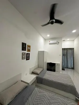 a bedroom with two beds and a ceiling fan at comfy soho in Seri Iskandar
