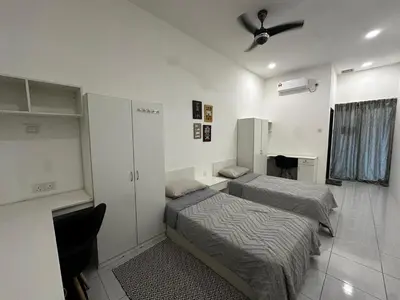 a bedroom with two beds and a ceiling fan at comfy soho in Seri Iskandar