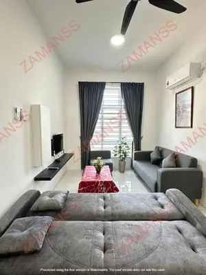 a living room with a large bed and a couch at zamanss homestay in Kampong Simee