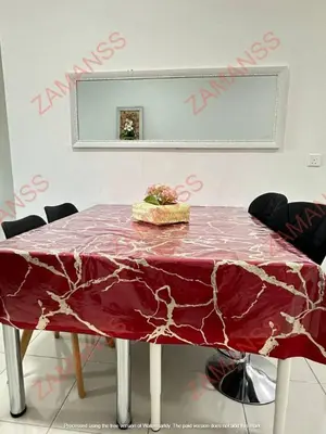 a table with a red table cloth on it at zamanss homestay in Kampong Simee