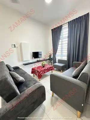 a living room with two couches and a table at zamanss homestay in Kampong Simee
