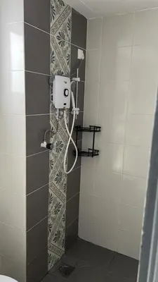 a shower in a bathroom with a shower at zamanss homestay in Kampong Simee