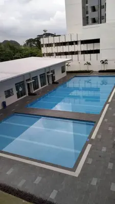 a large swimming pool in front of a building at zamanss homestay in Kampong Simee