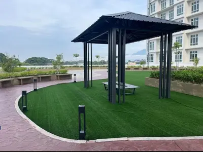 a pavilion with a bench in a field of grass at zamanss homestay in Kampong Simee