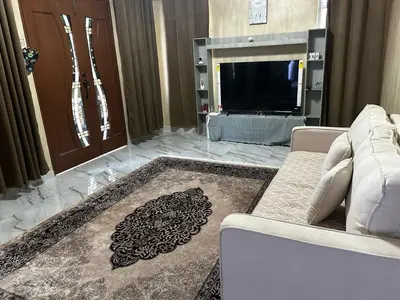 a living room with a couch and a television at Ariana Homestay in Sekincan