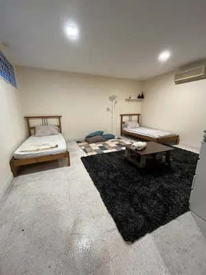 a room with two beds and a table at 728 NanasHomes Little Bungalow in Ipoh 10 pax in Ipoh