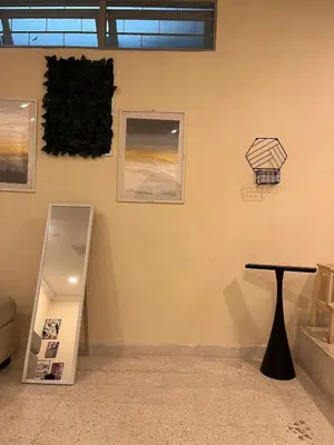 a room with a table and pictures on the wall at 728 NanasHomes Little Bungalow in Ipoh 10 pax in Ipoh