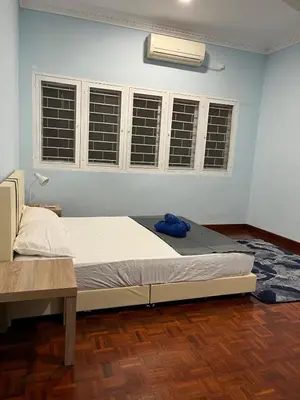 a bedroom with a bed in a room with windows at 728 NanasHomes Little Bungalow in Ipoh 10 pax in Ipoh