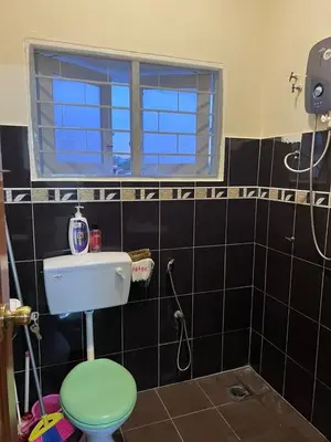 a bathroom with a green toilet and a window at 728 NanasHomes Little Bungalow in Ipoh 10 pax in Ipoh