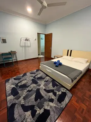 a bedroom with a bed and a rug at 728 NanasHomes Little Bungalow in Ipoh 10 pax in Ipoh