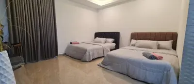 a bedroom with two beds and a window at CBHResort Agrofarm in Baling