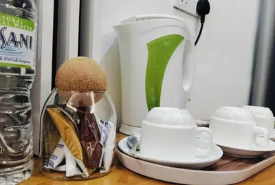 a counter with a coffee maker and cups and a blender at CBHResort Agrofarm in Baling