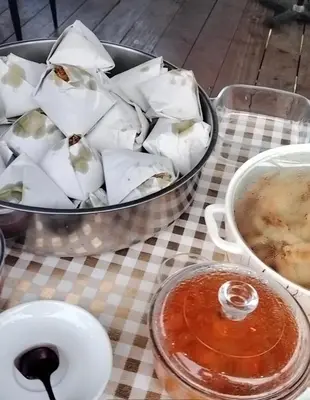a table with a pan of food and a bowl of soup at CBHResort Agrofarm in Baling