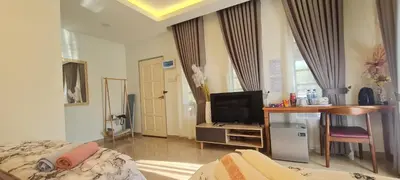 a room with a bed and a desk and a television at CBHResort Agrofarm in Baling
