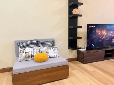 a living room with a couch with a television at G Home 2 - Ipoh City Centre The Majestic 2R2B in Ipoh
