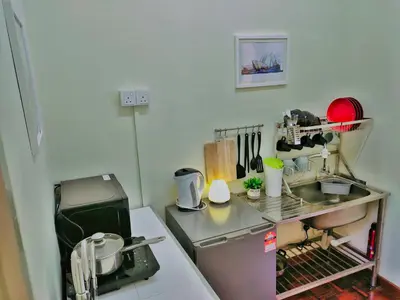 a small kitchen with a sink and a stove at Queensbay Mall, Up to 6 Pax, 3 Bedrooms, 2 Bathrooms, 1 Car Park by Star Home in Bayan Lepas
