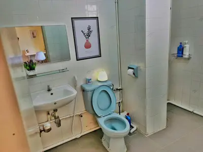 a bathroom with a blue toilet and a sink at Queensbay Mall, Up to 6 Pax, 3 Bedrooms, 2 Bathrooms, 1 Car Park by Star Home in Bayan Lepas