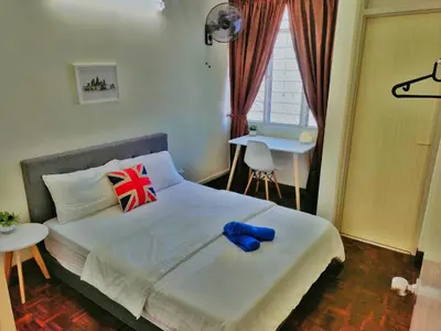 a bedroom with a bed and a table and a window at Queensbay Mall, Up to 6 Pax, 3 Bedrooms, 2 Bathrooms, 1 Car Park by Star Home in Bayan Lepas