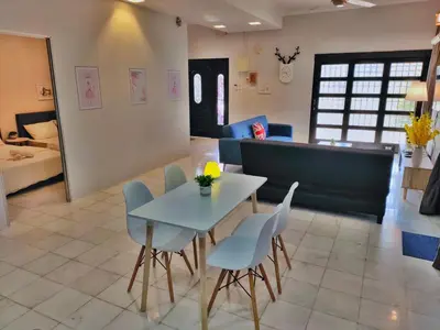 a dining room with a table and chairs in a room at Semi-Detached, Up to 24 Pax, 3200sqft, 4 Bedrooms, 3 Bathrooms, 4 Car Parks by Star Home in Gelugor