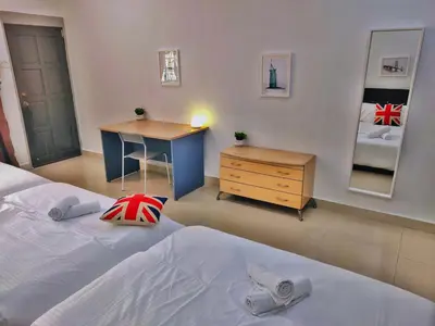 a bedroom with a bed and a desk and a mirror at Semi-Detached, Up to 24 Pax, 3200sqft, 4 Bedrooms, 3 Bathrooms, 4 Car Parks by Star Home in Gelugor