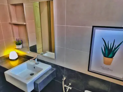 a bathroom with a sink and a picture of a plant at Semi-Detached, Up to 24 Pax, 3200sqft, 4 Bedrooms, 3 Bathrooms, 4 Car Parks by Star Home in Gelugor