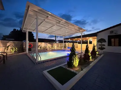 a white pergola over a swimming pool at night at Kaka Pool Homestay TmnIntan EventAllowed in Sungai Petani