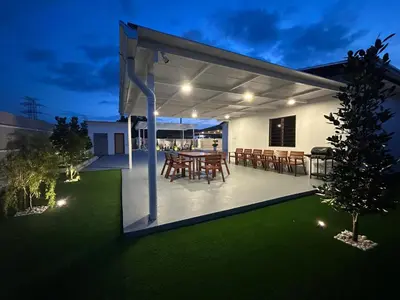 a backyard with a patio with a table and chairs at Kaka Pool Homestay TmnIntan EventAllowed in Sungai Petani