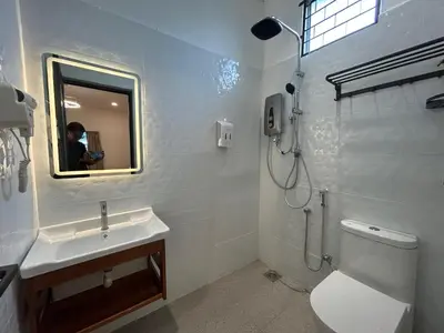 a bathroom with a sink and a toilet and a mirror at Kaka Pool Homestay TmnIntan EventAllowed in Sungai Petani