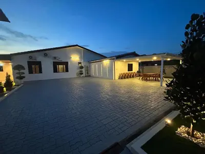 a house with a brick patio at night at Kaka Pool Homestay TmnIntan EventAllowed in Sungai Petani