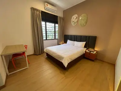 a bedroom with a bed and a desk and a window at Kaka Pool Homestay TmnIntan EventAllowed in Sungai Petani