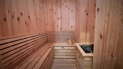 a sauna with a wooden paneled walls and a tub at Near Georgetown with Beautiful city view 2 room fit 4 to 7 pax in Jelutong