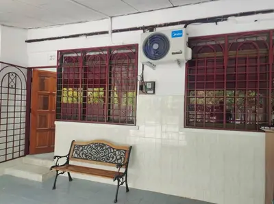 a bench sitting next to a wall with windows at DeStay Trong in Terong