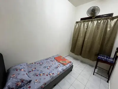 a small bedroom with a bed and a fan at DeStay Trong in Terong