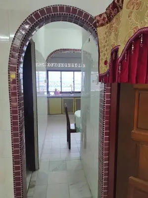 an archway in a room with a table and a chair at DeStay Trong in Terong