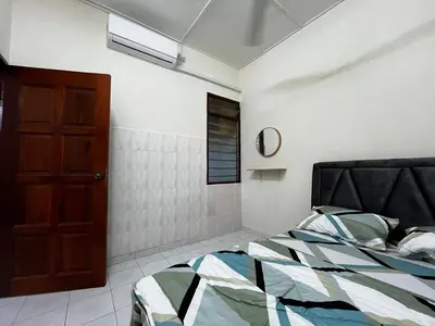 a bedroom with a bed and a window and a door at DeStay Trong in Terong